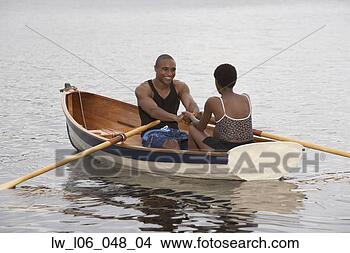 Stock Photo - african couple 
smiling in row 
boat. fotosearch 
- search stock 
photos, pictures, 
images, and photo 
clipart