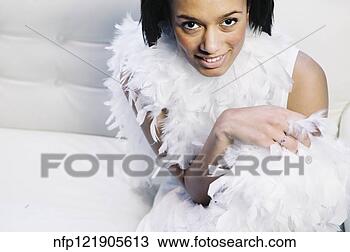 Stock Photo - african woman 
wearing feather 
boa. fotosearch 
- search stock 
photos, pictures, 
images, and photo 
clipart