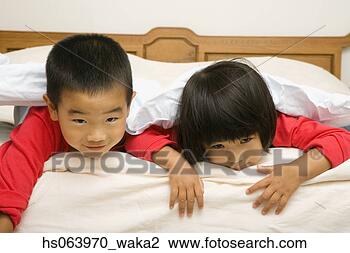 Stock Photo - asian brother 
and sister laying 
on bed. fotosearch 
- search stock 
photos, pictures, 
images, and photo 
clipart