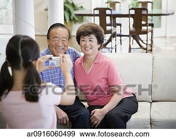Stock Photograph - asian girl taking 
photograph of 
grandparents. 
fotosearch - search 
stock photos, 
pictures, images, 
and photo clipart