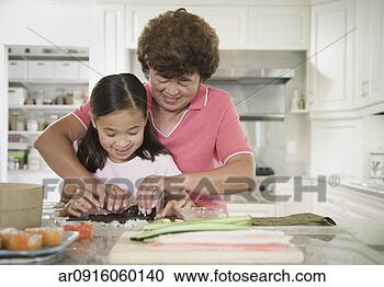 Stock Photography - asian grandmother 
and granddaughter 
making sushi roll. 
fotosearch - search 
stock photos, 
pictures, images, 
and photo clipart
