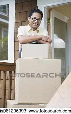 Stock Photo - asian man leaning 
on moving boxes 
on porch. fotosearch 
- search stock 
photos, pictures, 
images, and photo 
clipart