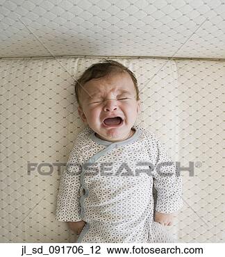 Stock Photo - high angle view 
of baby crying 
in crib. fotosearch 
- search stock 
photos, pictures, 
images, and photo 
clipart