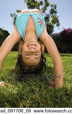 Stock Photograph - hispanic girl 
doing back bend 
in grass. fotosearch 
- search stock 
photos, pictures, 
images, and photo 
clipart
