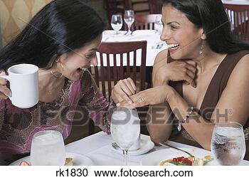 Stock Photography - hispanic woman 
showing ring to 
friend at restaurant. 
fotosearch - search 
stock photos, 
pictures, images, 
and photo clipart