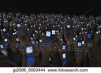Stock Photo - large group of 
people holding 
open cell phones 
up in air. fotosearch 
- search stock 
photos, pictures, 
images, and photo 
clipart