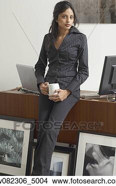 Stock Photo - middle eastern 
businesswoman 
next to framed 
photography. fotosearch 
- search stock 
photos, pictures, 
images, and photo 
clipart
