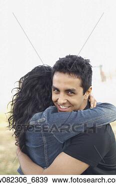 Stock Photograph - portrait of couple 
hugging outdoors. 
fotosearch - search 
stock photos, 
pictures, images, 
and photo clipart