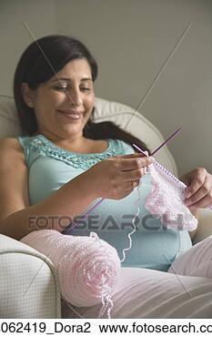 Stock Photo - pregnant hispanic 
woman knitting. 
fotosearch - search 
stock photos, 
pictures, images, 
and photo clipart