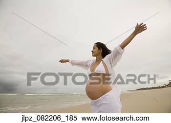 Stock Image - pregnant hispanic 
woman at beach. 
fotosearch - search 
stock photos, 
pictures, images, 
and photo clipart