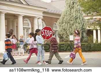 Stock Photo - student crossing 
guard holding 
stop sign while 
children cross 
street. fotosearch 
- search stock 
photos, pictures, 
images, and photo 
clipart