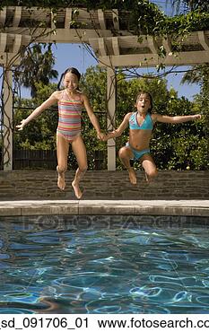 Stock Photography - two girls jumping 
into swimming 
pool. fotosearch 
- search stock 
photos, pictures, 
images, and photo 
clipart