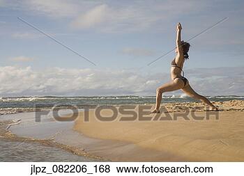 Stock Photo - woman practicing 
yoga on beach. 
fotosearch - search 
stock photos, 
pictures, images, 
and photo clipart