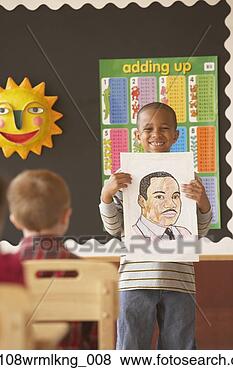Stock Photo - young african 
boy holding up 
picture in class. 
fotosearch - search 
stock photos, 
pictures, images, 
and photo clipart