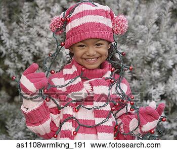 Stock Photography - young african 
girl in winter 
clothing with 
christmas lights. 
fotosearch - search 
stock photos, 
pictures, images, 
and photo clipart