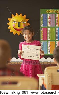 Stock Photography - young hispanic 
girl holding up 
paper in class. 
fotosearch - search 
stock photos, 
pictures, images, 
and photo clipart