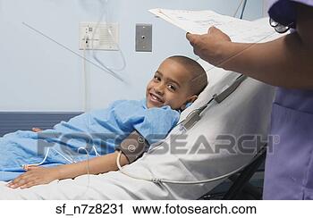 Stock Photography - african boy smiling 
in hospital bed. 
fotosearch - search 
stock photos, 
pictures, images, 
and photo clipart