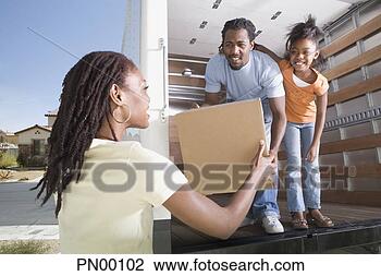 Stock Photo - african family 
unloading box 
out of moving 
truck. fotosearch 
- search stock 
photos, pictures, 
images, and photo 
clipart