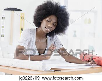 Stock Photograph - african female 
architect looking 
over blueprints. 
fotosearch - search 
stock photos, 
pictures, images, 
and photo clipart
