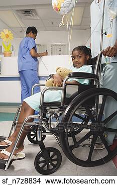 Stock Photo - african girl being 
pushed in wheelchair 
in hospital. fotosearch 
- search stock 
photos, pictures, 
images, and photo 
clipart