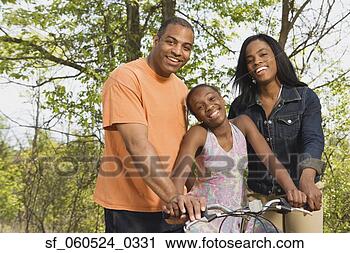 Stock Photography - african girl on 
bicycle with parents 
in park. fotosearch 
- search stock 
photos, pictures, 
images, and photo 
clipart