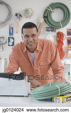 Stock Photo - african hardware 
store owner smiling 
behind counter. 
fotosearch - search 
stock photos, 
pictures, images, 
and photo clipart