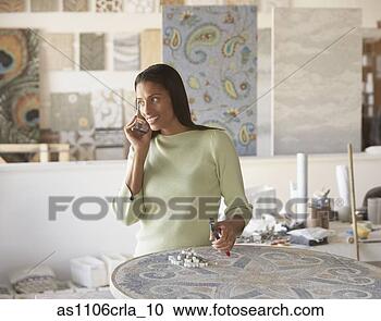 Stock Photography - african mosaic 
artist using cell 
phone in studio. 
fotosearch - search 
stock photos, 
pictures, images, 
and photo clipart