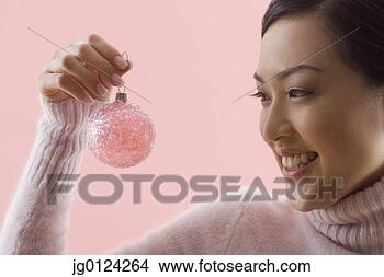 Stock Photo - asian woman holding 
christmas ornament. 
fotosearch - search 
stock photos, 
pictures, images, 
and photo clipart