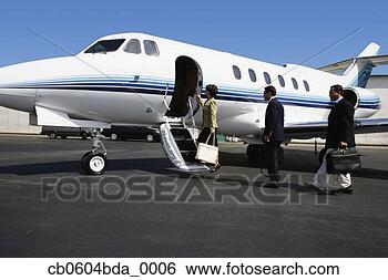Stock Photo - businesspeople 
boarding private 
airplane on tarmac. 
fotosearch - search 
stock photos, 
pictures, images, 
and photo clipart