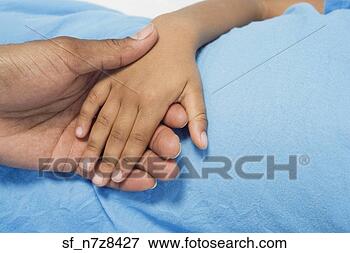 Picture - close up of african 
boy holding parent’s 
hand. fotosearch 
- search stock 
photos, pictures, 
images, and photo 
clipart
