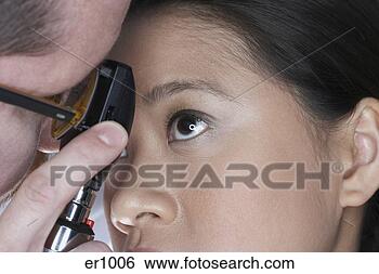 Stock Photo - close up of doctor 
examining asian 
woman’s eye. fotosearch 
- search stock 
photos, pictures, 
images, and photo 
clipart