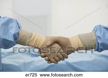 Stock Image - close up of gloved 
surgeons shaking 
hands. fotosearch 
- search stock 
photos, pictures, 
images, and photo 
clipart