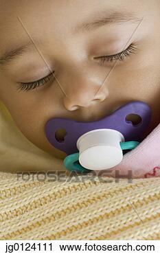 Stock Photography - close up of hispanic  baby sleeping  with pacifier.  fotosearch - search  stock photos,  pictures, images,  and photo clipart