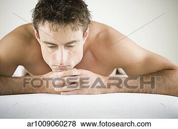 Stock Photo - close up of man 
with bare shoulders 
laying on stomach. 
fotosearch - search 
stock photos, 
pictures, images, 
and photo clipart