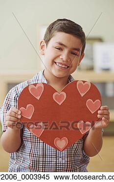 Stock Image - hispanic boy holding 
paper heart. fotosearch 
- search stock 
photos, pictures, 
images, and photo 
clipart