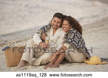Stock Photo - hispanic couple 
sitting on beach 
with champagne. 
fotosearch - search 
stock photos, 
pictures, images, 
and photo clipart