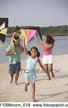 Stock Photo - hispanic family 
flying kites on 
beach. fotosearch 
- search stock 
photos, pictures, 
images, and photo 
clipart