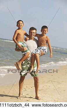 Stock Photo - hispanic father 
holding two sons 
at beach. fotosearch 
- search stock 
photos, pictures, 
images, and photo 
clipart