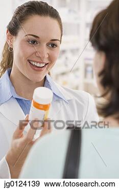 Stock Photograph - hispanic female 
pharmacist giving 
medication to 
customer. fotosearch 
- search stock 
photos, pictures, 
images, and photo 
clipart