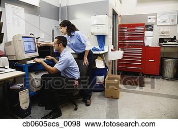 Stock Photo - hispanic man and 
woman using computer 
in office of auto 
repair shop. fotosearch 
- search stock 
photos, pictures, 
images, and photo 
clipart