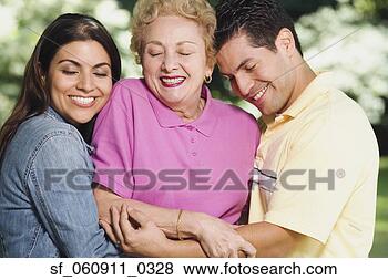 Stock Photo - hispanic mother 
with adult children 
hugging. fotosearch 
- search stock 
photos, pictures, 
images, and photo 
clipart