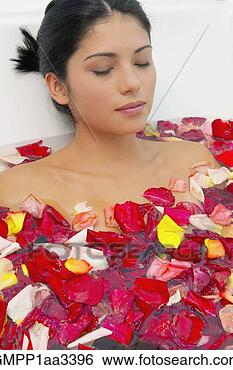 Stock Photo - hispanic woman 
with eyes closed 
in bath of flower 
petals. fotosearch 
- search stock 
photos, pictures, 
images, and photo 
clipart