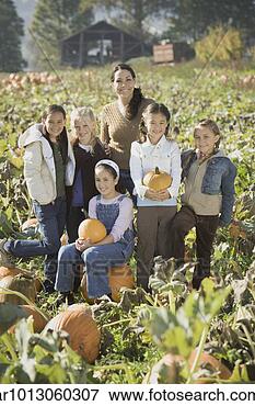 Picture - hispanic woman 
with group of 
children in pumpkin 
patch. fotosearch 
- search stock 
photos, pictures, 
images, and photo 
clipart