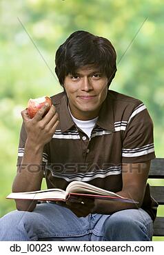Stock Photo - indian man eating 
fruit and reading. 
fotosearch - search 
stock photos, 
pictures, images, 
and photo clipart