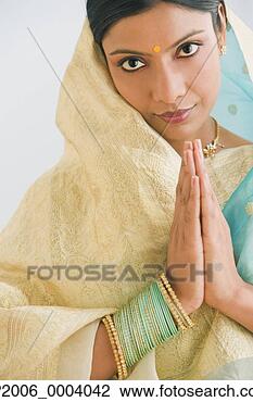 Stock Photo - indian woman in 
traditional clothing 
praying. fotosearch 
- search stock 
photos, pictures, 
images, and photo 
clipart