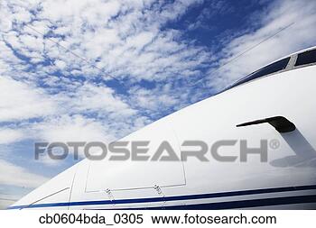 Stock Image - nose of airplane 
under blue sky. 
fotosearch - search 
stock photos, 
pictures, images, 
and photo clipart