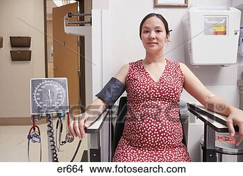 Stock Photo - pregnant asian 
woman with blood 
pressure cuff 
in hospital. fotosearch 
- search stock 
photos, pictures, 
images, and photo 
clipart