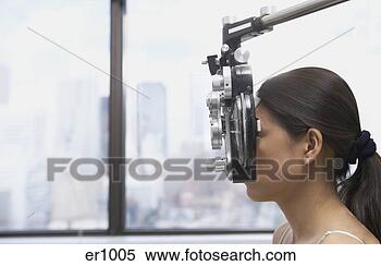 Stock Image - profile of asian 
woman’s face behind 
ophthalmology 
equipment. fotosearch 
- search stock 
photos, pictures, 
images, and photo 
clipart