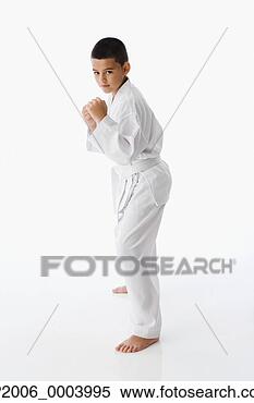 Stock Image - studio shot of 
hispanic boy in 
martial arts stance. 
fotosearch - search 
stock photos, 
pictures, images, 
and photo clipart