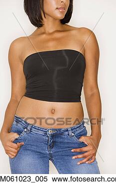 Stock Image - studio shot of 
young hispanic 
woman in strapless 
top and jeans. 
fotosearch - search 
stock photos, 
pictures, images, 
and photo clipart